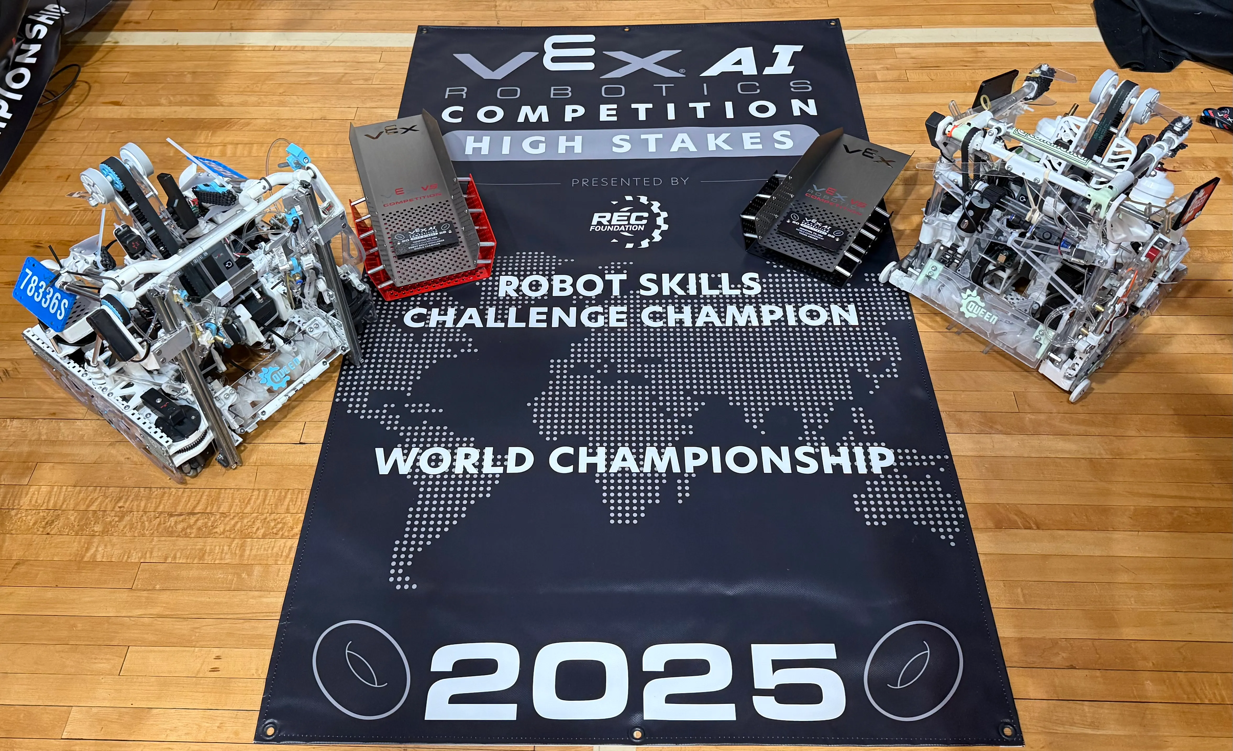 Image of QUEEN VEXAI Robots with World Skills Champion Banner